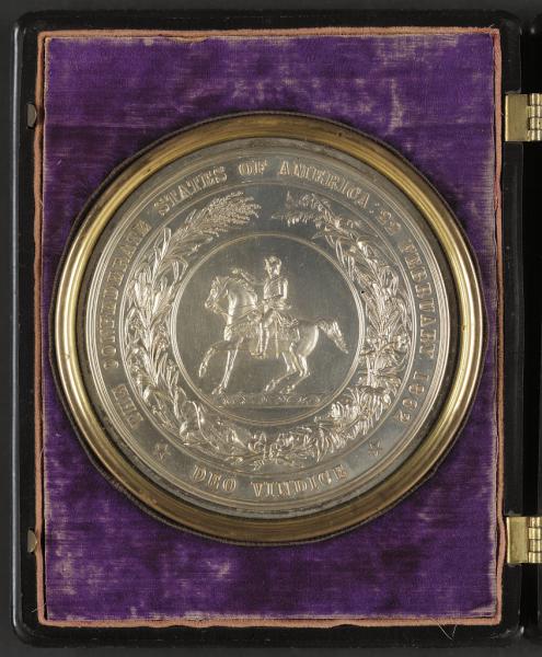 A brass medallion displaying the seal of the Confederate States of America. Courtesy of the Library of Congress.